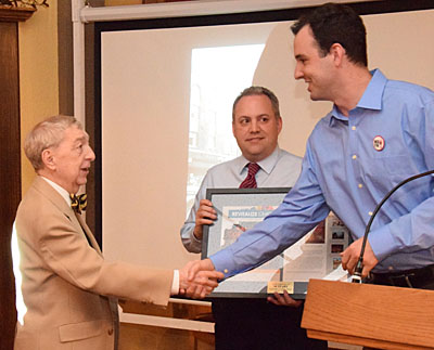 Balyeat's Coffee Shop owner Dale Davies (right) is congratulated by Main Street Van Wert Program Manager Adam Ries, while MSVW Board member Mark Verville looks on. (Dave Mosier/Van Wert independent)