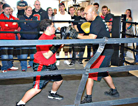 Paul Barton (right) spars with a young customer at his new boxing gym in downtown Van Wert. (photo submitted)