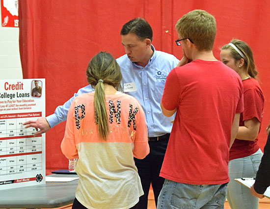 Banker Mark Schumm talks to high school seniors about the cost of credit during Thursday's Real Money. Real World. simulation in the VWHS gymnasium. (Dave Mosier/Van Wert information)