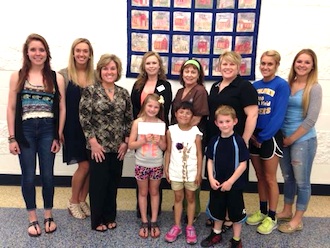 Pictured are Lincolnview staff members Slusher, Elliot and administrator McKinney presenting the check to Jamie Orozco, Community Manager of Relay for Life. Also pictured are Lincolnview elementary students and members of the International National Honor Society who were active in helping with this event. (Photo submitted.)