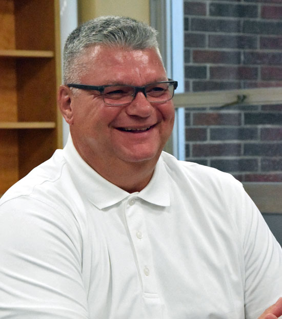 Van Wert High School Principal Bill Clifton listens as he is given a new position during a special meeting of the Van Wert City Board of Education on Monday. (Dave Mosier/Van Wert independent)