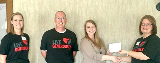 Rebecca White (right), chair of the Buckeye Insurance Professionals Ways and Means Committee, presents a Visa card to Katelin Toland, YWCA Youth Enrichment Program supervisor, while fellow BIP members Kristi Bell and Scott Mull look on. (photo submitted)