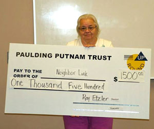 Carol Hennis of NeighborLink Van Wert is shown with a ceremonial check representing the amount Paulding Putnam Electric Cooperative donated to that organization. (photo submitted)