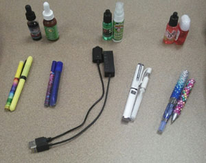 Eight side-by-side comparisons of an e-cigarette product (left side of each pair) next to a similar-looking school supply or household item (right side of each pair). (submitted photo)