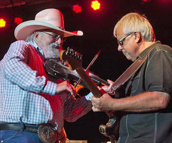 Charlie Daniels (left) jams with a band member during the group's concert in front of the grandstand on Tuesday night. (Bob Barnes/Van Wert independent)