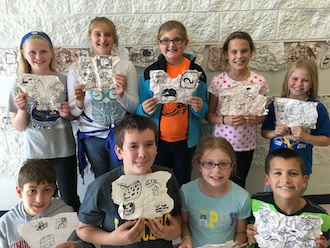 Fifth graders have been learning about the ancient civilization of the Maya. Students learned that the Maya were the first in the Western Hemisphere to form a system of writing. In the picture, students are holding Mayan hieroglyphics, which they used to create their own sentence.  (Photo submitted.)