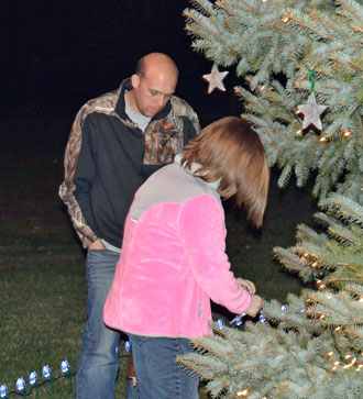 Eric and Kaila Flory hang a star in memory of their son, Beau Flory. (photo submitted)