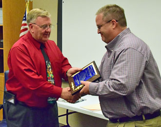 Crestview Superintendent Mike Estes (left) presents outgoing board member Mike Schlagbaum with a plaque honoring his service to the school district. (Dave Mosier/Van Wert independent)