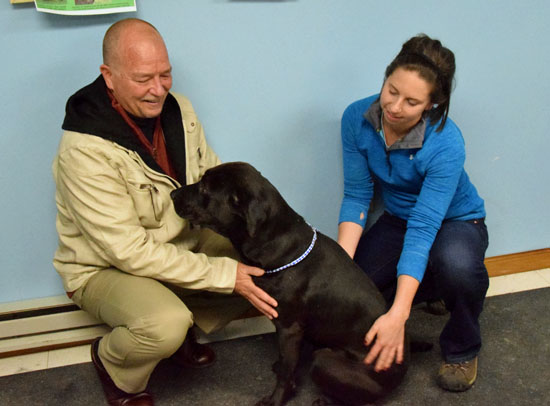 Pete Weir, Humane Society board president, and Sarah Robeson, Volunteer Committee chair, play with Micka, one of the shelter's residents. (Dave Mosier/Van Wert independent)