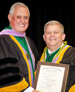 Local dentist Dr. Kevin Laing (right) is shown during his induction into the International College of Dentists. (photo submitted)