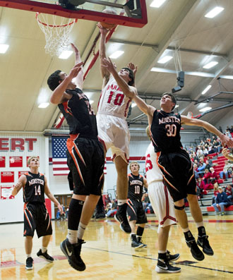 Van Wert's Colin Smith (10) goes up high for a layup during Wednesday's non-conference game against Minster. The Cougars earned their first win of the season, 51-47, against the Wildcats. (Bob Barnes/Van Wert independent)