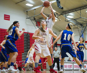 Van Wert's Cassidy Myers (2) goes up over teammate Abby Jackson (12) for a basket against Delphos St. John's in a non-conference game won by the Blue Jays, 48-30. (Bob Barnes/Van Wert independent)