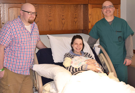 Larry Dunlap (left) watches as his wife, Charity, holds their son, Charlie Xavier, Van Wert County Hospital's 2016 New Year's baby. Dr. Alberto Delgado (right) delivered Charlie at 7:49 a.m. Sunday, January 3. (VWCH photo)