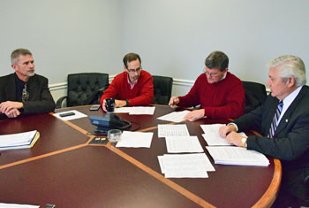 Van Wert County Commissioners (from the left) Thad Lichtensteiger, Todd Wolfrum, and Stan Owens review a list of BR&E companies with Van Wert Mayor Jerry Mazur. (Dave Mosier/Van Wert independent)