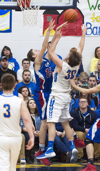 Lincolnview's Chandler Adams (30) and Crestview's Javin Etzler (15) collide during the teams' battle for supremacy in the Northwest Conference on Friday. The Lancers won the game, 60-48. (Bob Barnes/Van Wert independent)
