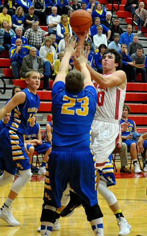 Cougar Colin Smith (10) shoots over a Marion Local defender in a game won by the Flyers 61-58. (Jan Dunlap/Van Wert independent)