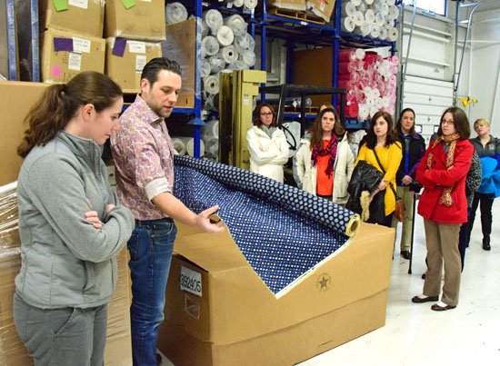 Sticky Rammel, national sales manager for KAM Manufacturing, shows Lincolnview teachers some of the fabric used in the company's Stephanie Dawn line of purses. (Dave Mosier/Van Wert independent)