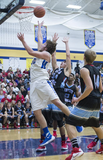 Lincolnview's Chandler Adams (30) gets inside for a layup against Lima Central Catholic, but the Lancers lost to LCC 62-44 in a match-up of top-ranked area teams. (Bob Barnes/Van Wert independent)