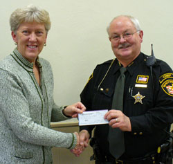 Kathy Hemmelgarn, Midwest Electric Community Connection Fund trustee, donates $500 to Keith Allen, chief deputy of Van Wert County DARE, for supplies and prizes for DARE events. (photo submitted)