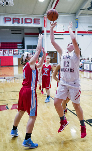 Lady Cougar Abby Jackson (12) puts in a layup during Monday's game against LCC. The Lady T-Birds won the contest, 60-44. (Bob Barnes/Van Wert independent)