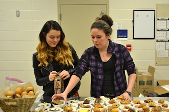 Seniors and Art Club members Nevada Smith and Alyssa Walter serve dessert at Empty Bowls Night last Friday. (Photo submitted.)