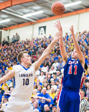 Crestview's Connor Lautzenheiser (11) puts in a shot over Lincolnview defender Austin Leeth (10) during Friday night's Division IV district championship game. (Bob Barnes/Van Wert independent)