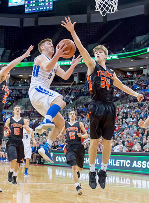 Lancer Austin Leeth (3) goes up high for a layup over a Jackson Center defender during Lincolnview's 52-39 state semifinals victory on Friday. (Bob Barnes/Van Wert independent)