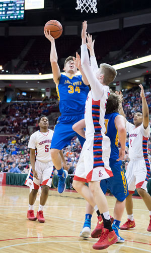 Hayden Ludwig (34) goes up over 6-8 center Jeremiah Selle to score for Lincolnview in the Lancers' 72-54 loss in the Division IV state championship game Saturday at Value City Arena on the Ohio State campus. (Bob Barnes/Van Wert independent)