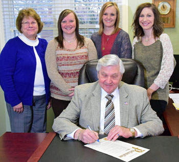 Van Wert Mayor Jerry Mazur signs a proclamation designating April 10-16 Crime Victims' Rights Week in the city of Van Wert. Looking on are (from the left) Kathy Taylor of Crisis Care, Christine Eversole of Crime Victims Inc., and Jody Wannemacher and Jamie Evans from the YWCA's domestic violence program. (Dave Mosier/Van Wert independent)