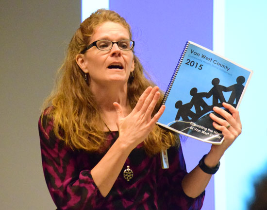 Van Wert County Hospital staff member Anne Dunn holds up a copy of the 2015 Van Wert County Community Health Assessment during a presentation on Wednesday. (Dave Mosier/Van Wert independent)