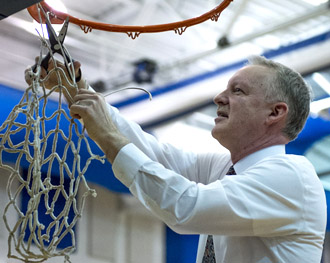 Crestview Girls' Head Coach Greg Rickard cuts down the net from the Lady Knights' Division IV sectional championship this season. (Bob Barnes/Van Wert independent)