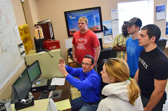 Neil Voje (seated), manager of Iberdrola Renewables' Blue Creek Wind Farm, explains the workings of the wind turbines to a group of Ohio State engineering students. (Dave Mosier/Van Wert independent)