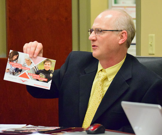 Vantage Career-Technical Center Director Pete Prichard holds up a marketing brochure for Adult Education programs during Thursday's Vantage Board of Education meeting. (Dave Mosier/Van Wert independent)