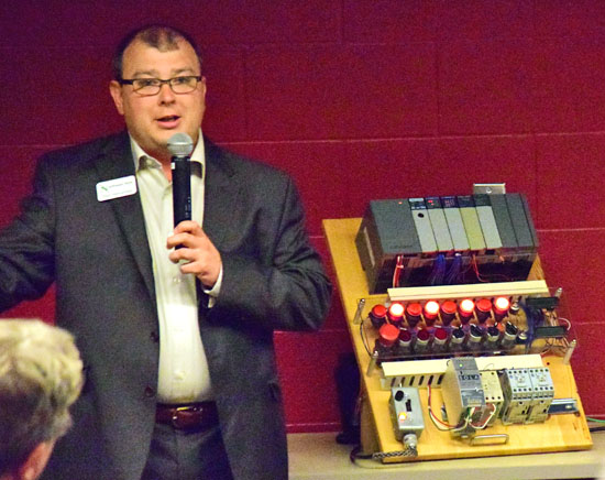 Todd Hernandez, vice president for innovation at Northwest State Community College, demonstrates a training machine during Tuesday's Manufacturing Summit at Vantage Career Center. (Dave Mosier/Van Wert independent)
