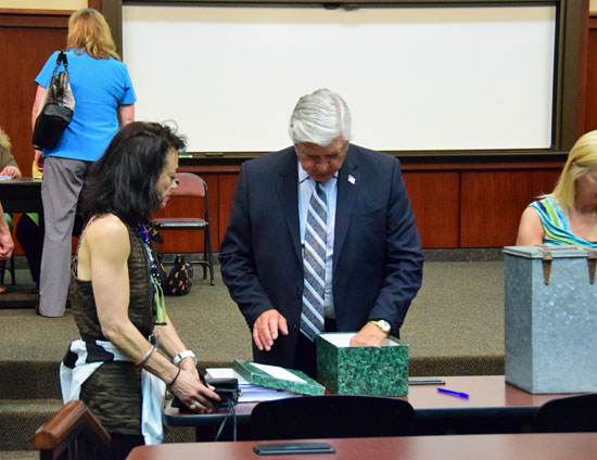 Van Wert Mayor Jerry Mazur (center in blue suit) provides information to a potential voter during Monday evening's election of at-large members of the Van Wert Area Economic Development Corporation. Balloting was held in the First Federal Lecture Hall of the Niswonger Performing Arts Center of Northwest Ohio. (Dave Mosier/Van Wert independent)