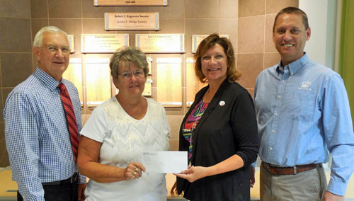 Dianne Cooper (second from left), Cooper Farms corporate secretary, and Marv Lefeld (right), chief financial officer, present a $75,000 check from the Cooper Family Foundation to Julie Miller, WOEF development officer, and Tom Knapke, WOEF Board member. (photo submitted)