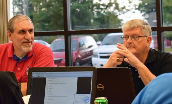 Crestview Board member Lonnie Nedderman (left), who is also Vantage Board president, gives his report on Vantage's August meeting while Crestview Board President John Auld listens. (Dave Mosier/Van Wert independent)
