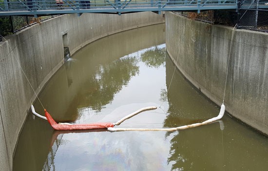 This absorbent boom was one of several placed in Town Creek in an attempt to mop up gasoline that spilled into the creek on Sunday. (Scott Truxell/for the VW independent)