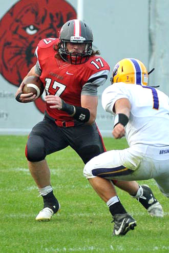 Cougar Evan Williams (17) looks for running room against Bryan during both teams' opener on Friday. Jan Dunlap/Van Wert independent