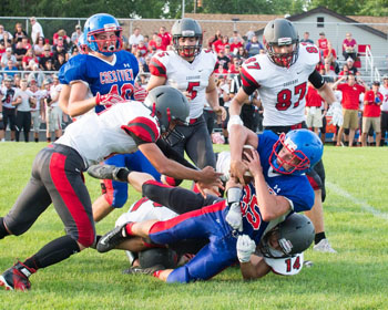 Crestview's Payton Knittle (35) is brought down by a host of Cougar defenders after a gainer in Friday's scrimmage between the two teams at Crestview. (Bob Barnes/Van Wert independent)