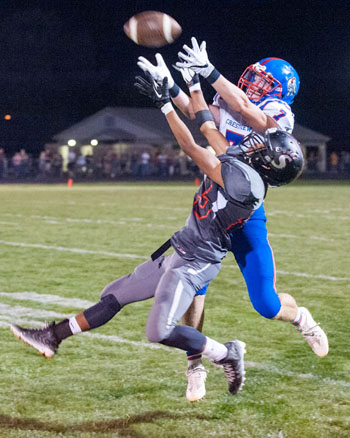 Crestview's Grant Schlagbaum (7) hauls in a pass over a Spencerville defender in Friday's Northwest Conference game won by the Bearcats, 44-41. Bob Barnes/Van Wert independent
