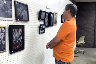 Judge David Prior prepares to make his selections at the Fair's Photography Exhibit.   (Photo submitted.)