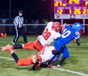 Knight quarterback Drew Kline (10) drags two defenders with him on a run in Friday's game against Bluffton. Bob Barnes/Van Wert independent