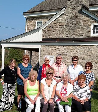 Shown in front of the Waldschmidt Homestead are (front row, from the left) Barbara Steptoe, Linda Schumm, Linda Hoffman, and Janet Mohr; (back row) Virginia Burroughs, Gina Say, Gloria Fast, Bill Fast, Karen Myers, and Mickey McConahay. (DAV photo)