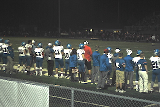 Several of the football team members watch from the sidelines during the game against Delphos Jefferson last Friday night at Delphos Jefferson during first quarter.  (Photo submitted.)