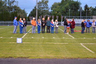 A few of the seniors with their parents are lined up during the ceremony at the football game last Friday night. (Photo submitted.)