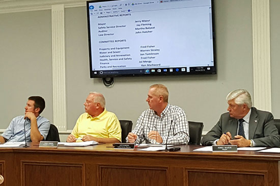 Councilmen At-Large Warren Straley (left) and Fred Fisher, listen to a statement by colleague Jon Tomlinson, while Mayor Jerry Mazur (right) and Safety-Service Director Jay Fleming also listen. Scott Truxell/Van Wert independent