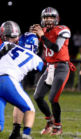 Van Wert quarterback Storm Pierce (13) looks for a receiver downfield during Friday's game against Defiance. The Cougars lost 27-14 in its last home game of the season. Jan Dunlap/Van Wert independent