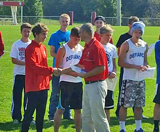Van Wert runner Cal Wolfrum (in red) earns First Team All-WBL honors by finishing first at the league cross country meet on Saturday. (photo submitted)