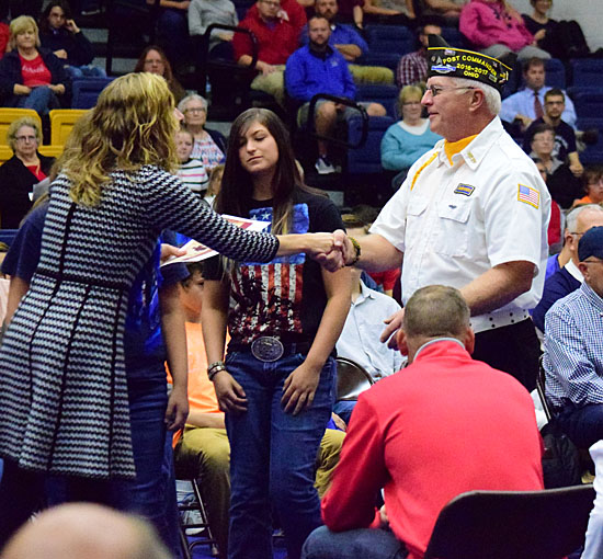 Veteran Steve Pollock (right), commander of Veterans of Foreign Wars Post 5803, was presented a certificate of appreciation honoring his service by teacher Anna Baker during Lincolnview Local Schools' Veterans Day program on Thursday (click here for more photos). Dave Mosier/Van Wert independent